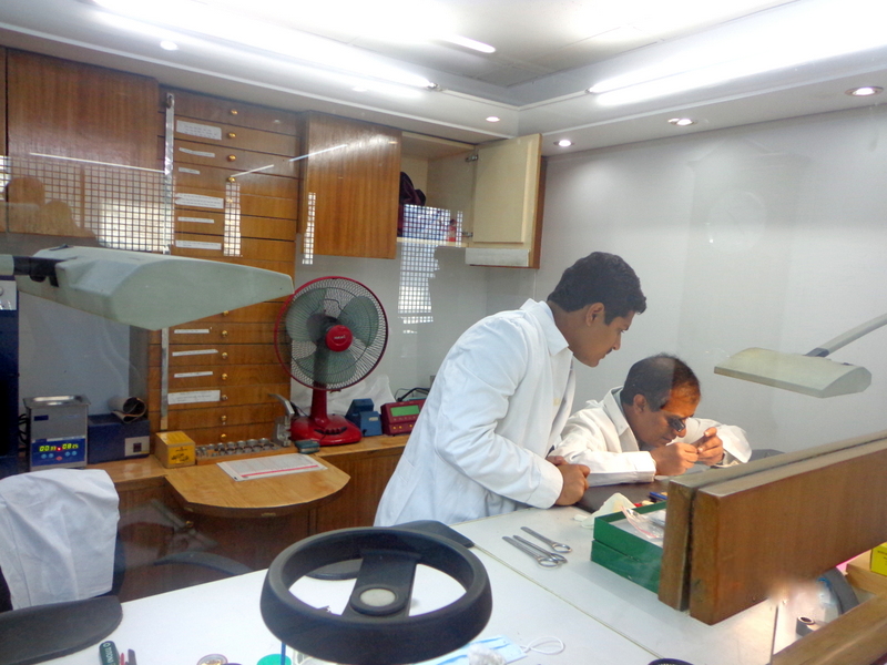 A watch movement being assembled by a watchmaker.